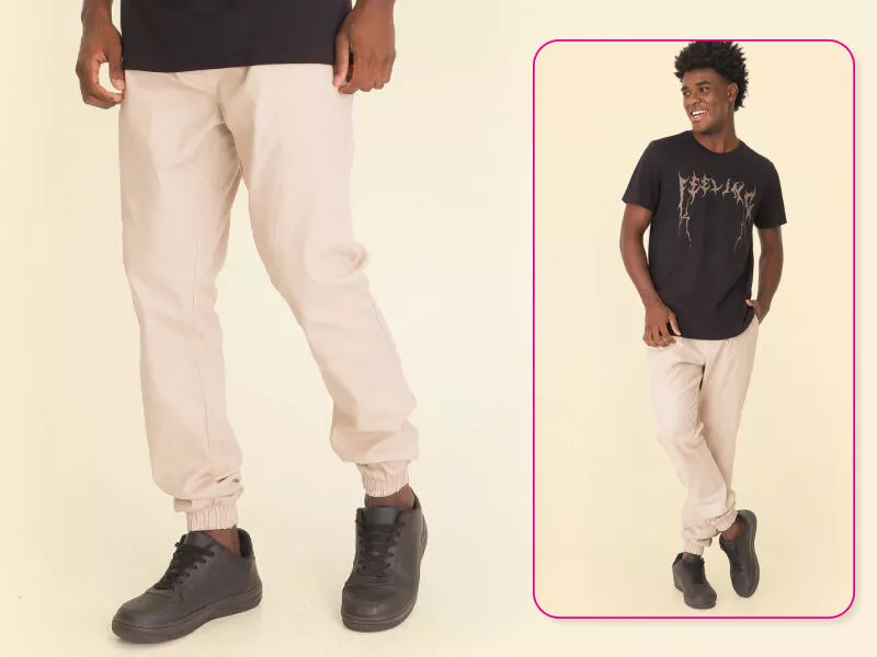 Jovem usando calça clara e camiseta preta