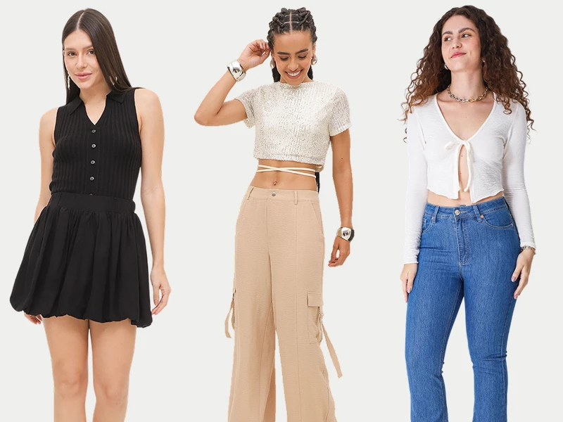 Três mulheres com looks de moda: saia balão preta, top brilhante com calças bege e blusa branca com calças de ganga.