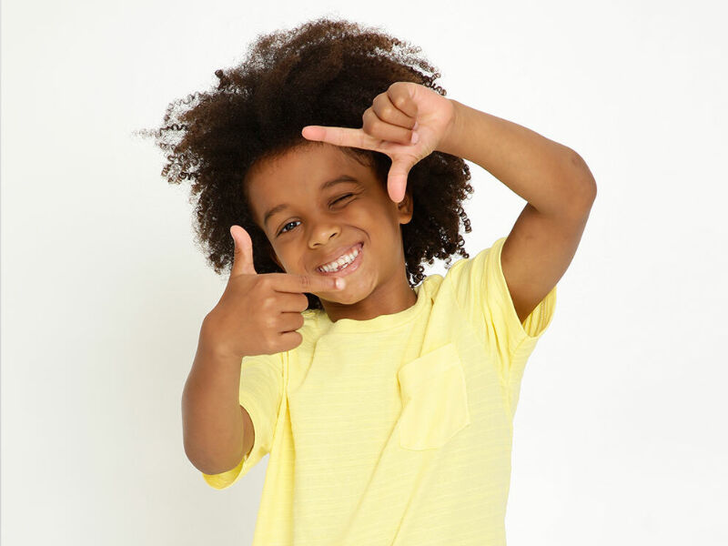 lookscopa 10 Criança sorrindo e fazendo sinal positivo com as mãos